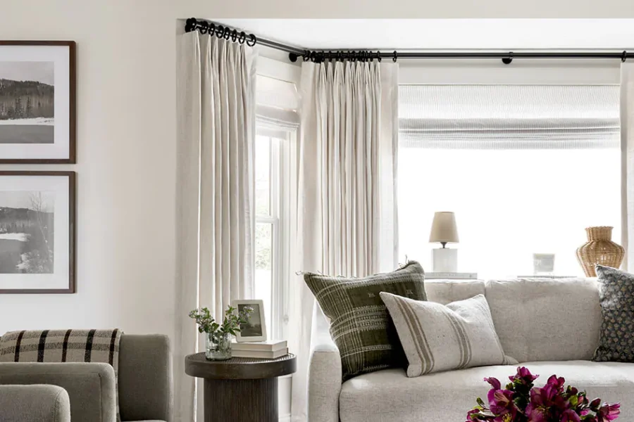 the-shade-store-flat-roman-shades-windsor-stripe-toast-tailored-pleat-drapery-linen-sheers-oatmeal-bay-window-curtains-hero-2022-studio-mcgee-950x630px.jpg
